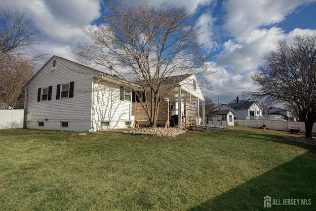 exterior space with an outdoor structure, a fenced backyard, a lawn, and a shed