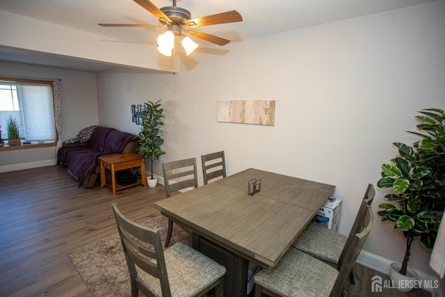 dining space with a ceiling fan, wood finished floors, and baseboards