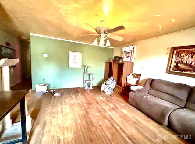 living area with a ceiling fan and wood finished floors