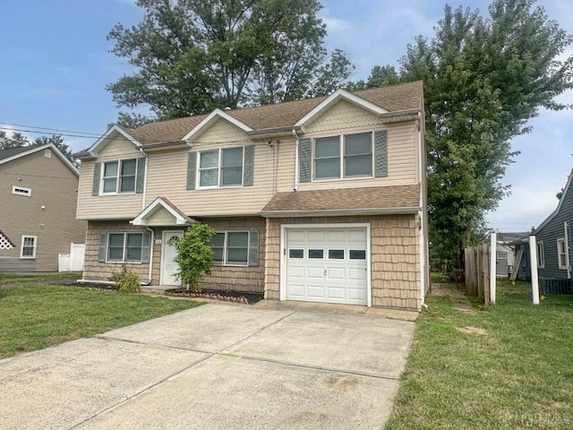 view of front of property featuring a front lawn and a garage