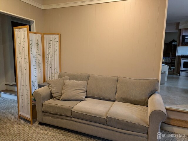 living room featuring ornamental molding and carpet flooring