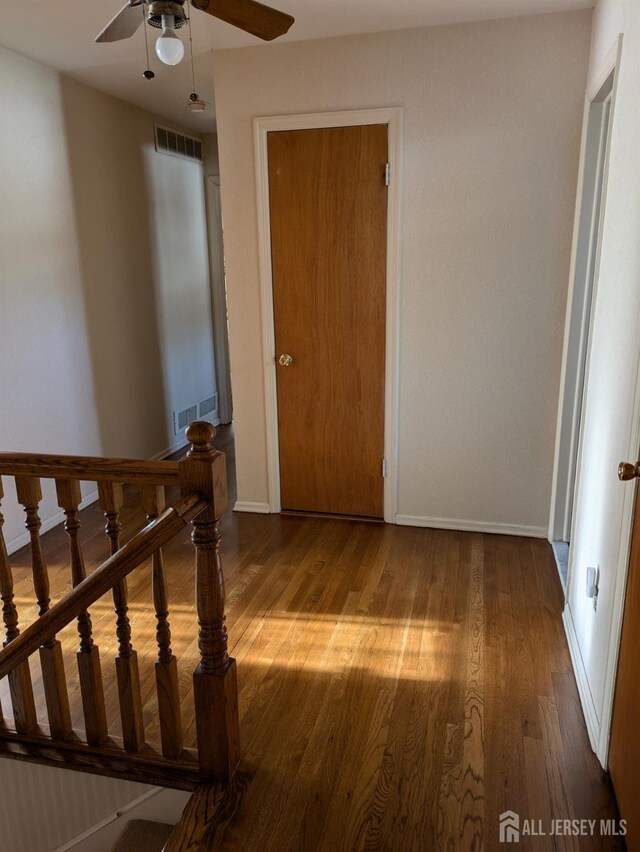 interior space featuring wood-type flooring and ceiling fan