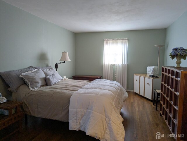 bedroom featuring dark wood-type flooring