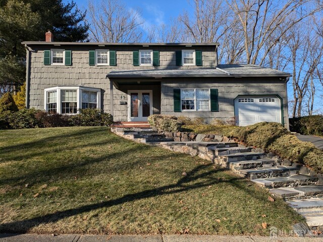 view of front facade with a front yard and a garage