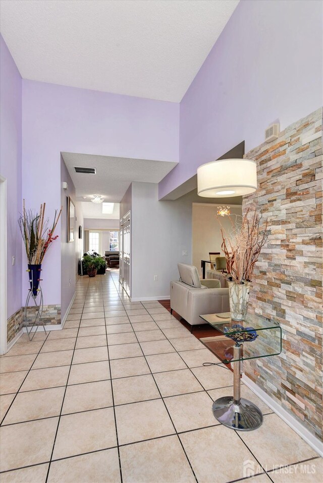 hall with light tile patterned floors