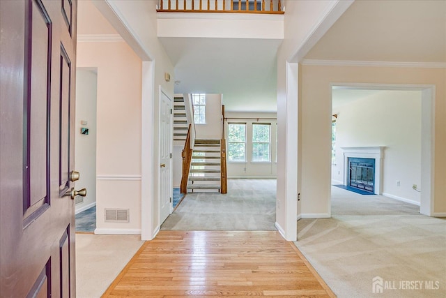 2 Durham Way E, Windsor, NJ 08520 - foyer featuring light carpet, ornamental molding, stairs, a fireplace, and baseboards