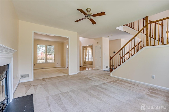 2 Durham Way E, Windsor, NJ 08520 - unfurnished living room with ceiling fan, a glass covered fireplace, carpet, stairs, and baseboards