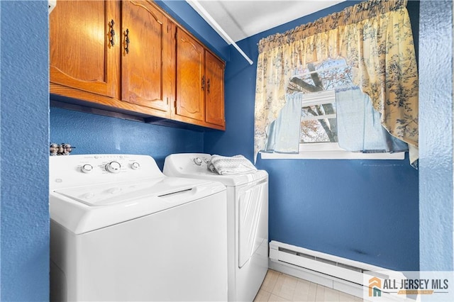 washroom with washer and clothes dryer, cabinet space, a textured wall, baseboards, and a baseboard heating unit