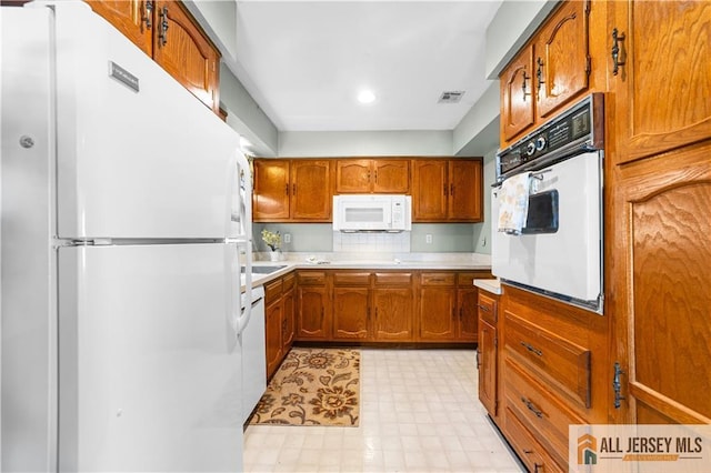 532 Old Nassau Rd Unit 532N, Monroe, NJ 08831 - kitchen featuring white appliances, brown cabinetry, light countertops, light floors, and recessed lighting