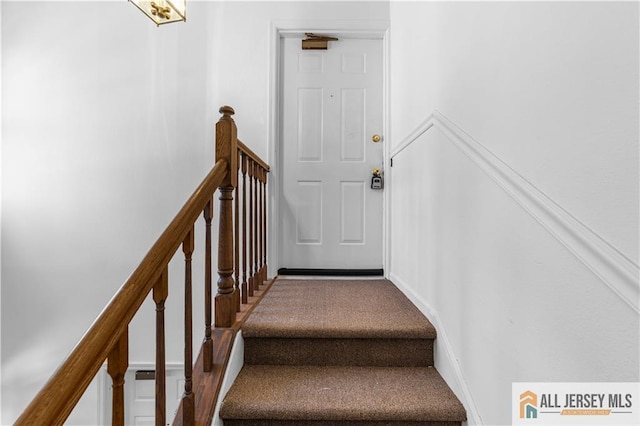 stairs featuring carpet floors