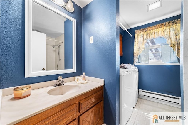 532 Old Nassau Rd Unit 532N, Monroe, NJ 08831 - bathroom featuring baseboard heating, separate washer and dryer, vanity, a textured wall, and tile patterned flooring