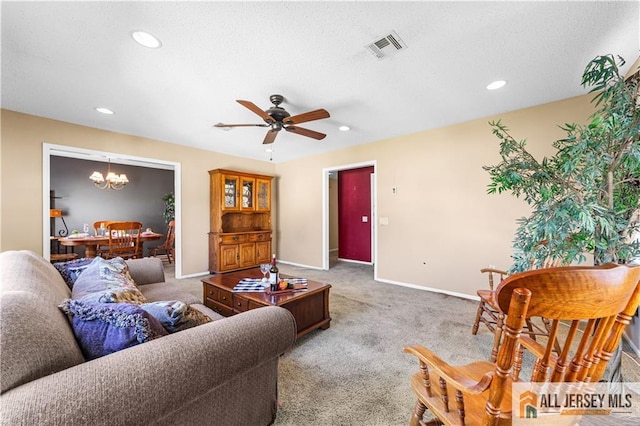 living area featuring a chandelier, baseboards, recessed lighting, ceiling fan, and carpet