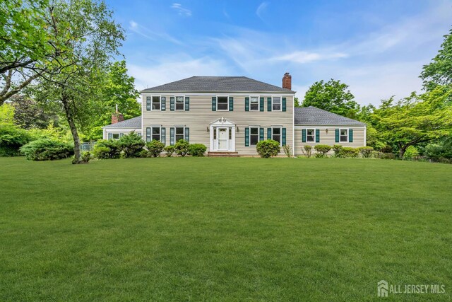 21 Shadyside Ct, Branchburg, NJ 08876 - colonial inspired home with a chimney, a front yard, and a shingled roof