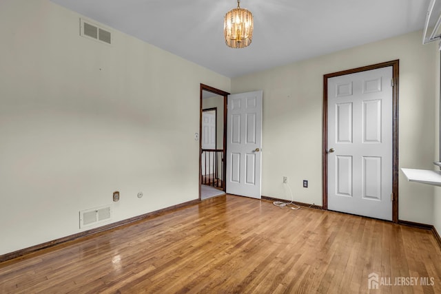 21 Shadyside Ct, Branchburg, NJ 08876 - unfurnished bedroom featuring a chandelier and wood-type flooring