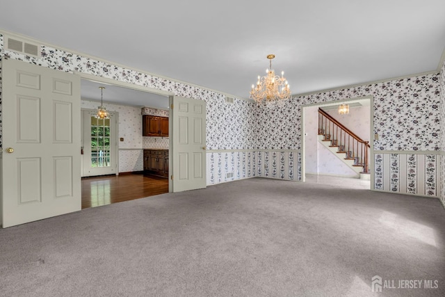 21 Shadyside Ct, Branchburg, NJ 08876 - unfurnished living room with wallpapered walls, carpet floors, a chandelier, stairway, and crown molding