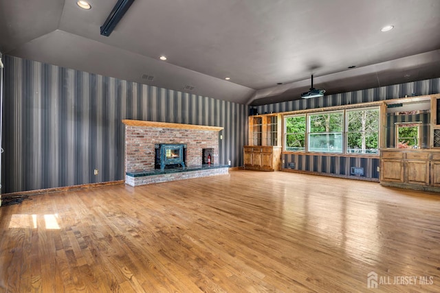 21 Shadyside Ct, Branchburg, NJ 08876 - unfurnished living room with lofted ceiling, wallpapered walls, wood finished floors, recessed lighting, and a brick fireplace