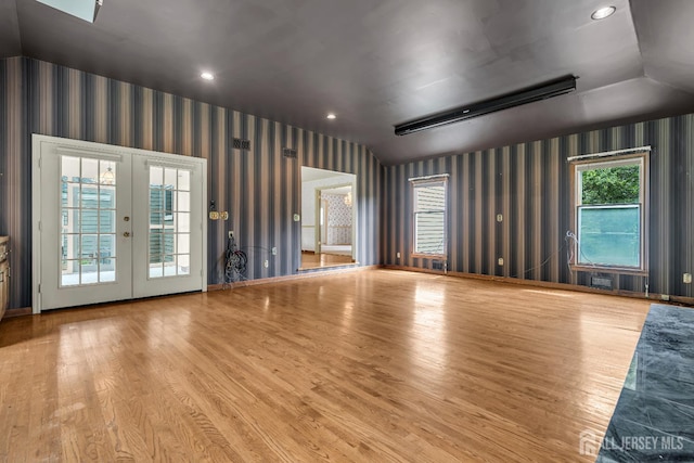 21 Shadyside Ct, Branchburg, NJ 08876 - unfurnished living room featuring wallpapered walls, wood finished floors, vaulted ceiling, french doors, and recessed lighting