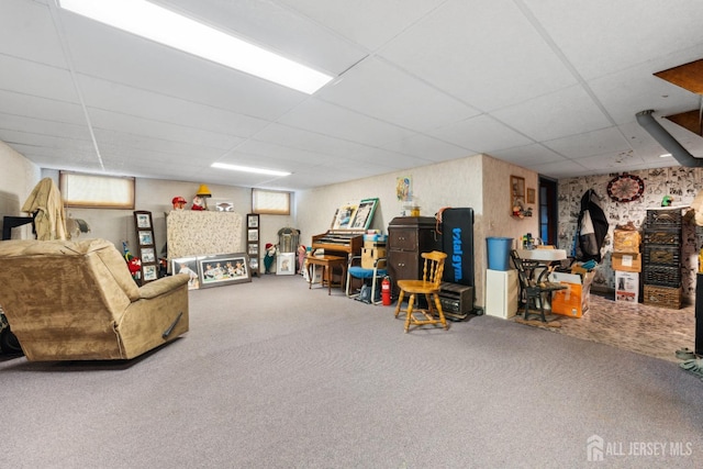 living room with carpet and a paneled ceiling