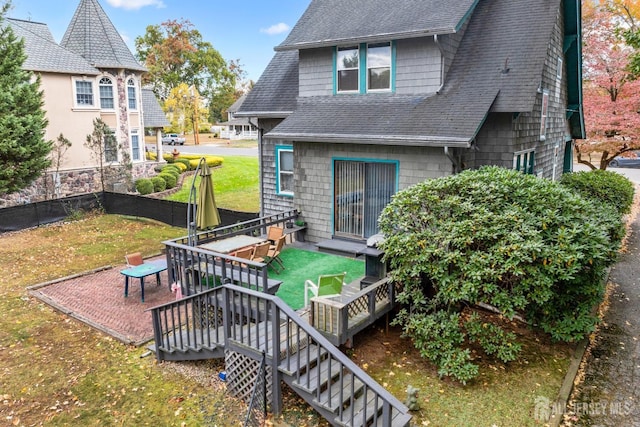 rear view of property with a lawn and a patio