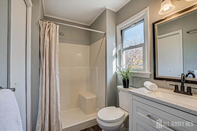 full bath featuring toilet, a shower stall, crown molding, and vanity