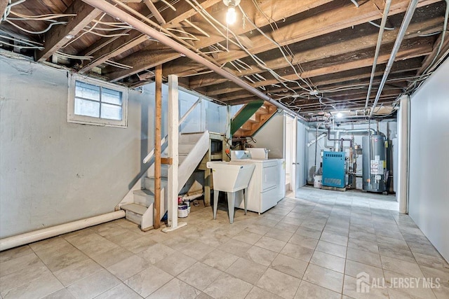 below grade area featuring a sink, water heater, stairs, a heating unit, and washer / dryer