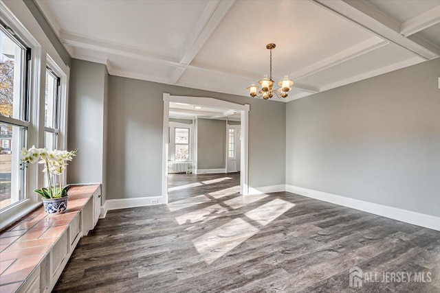 spare room with radiator, baseboards, and dark wood-style flooring