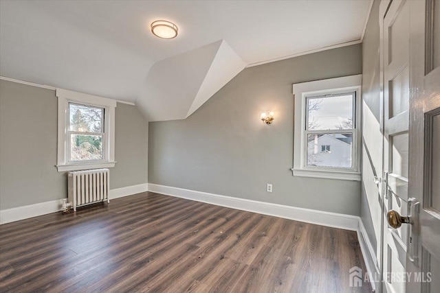 bonus room with baseboards, dark wood-style flooring, vaulted ceiling, and radiator