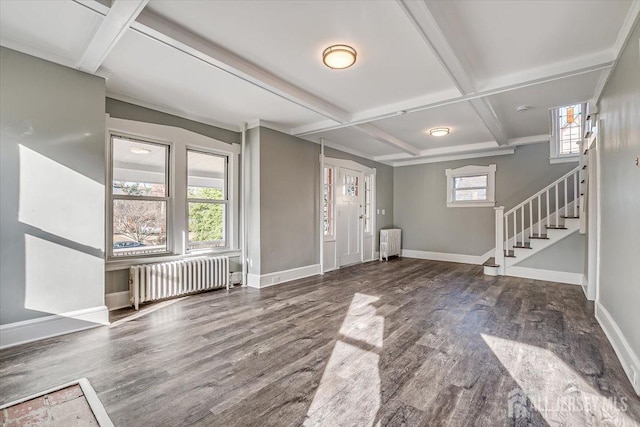 foyer featuring radiator heating unit, stairs, baseboards, and coffered ceiling