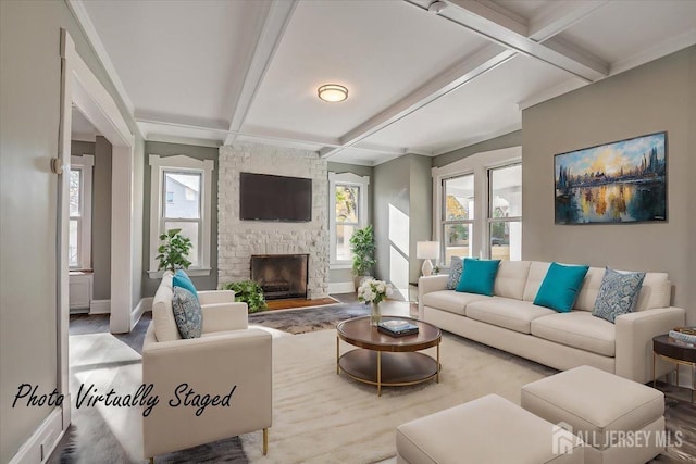 living area featuring coffered ceiling, beamed ceiling, and a stone fireplace