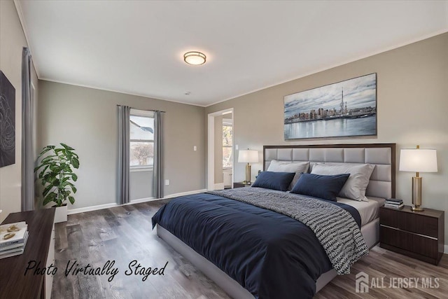 bedroom featuring crown molding, baseboards, and wood finished floors