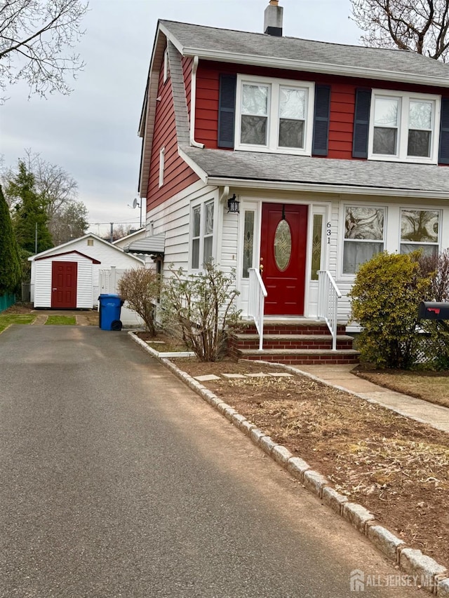 view of front of house featuring a storage shed