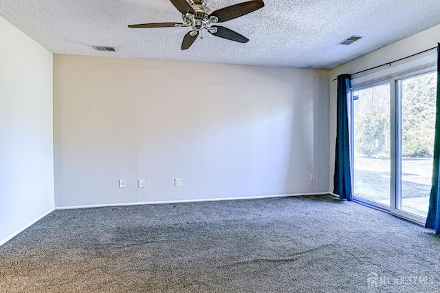 unfurnished room featuring visible vents, carpet floors, a textured ceiling, and baseboards