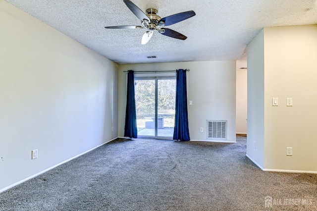 empty room with a textured ceiling, carpet, visible vents, and baseboards