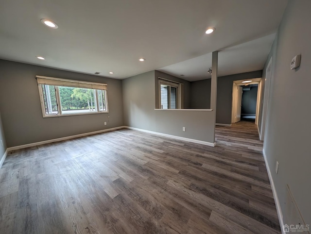 spare room featuring dark wood-type flooring