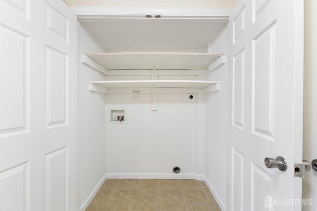 clothes washing area with laundry area, hookup for an electric dryer, baseboards, and washer hookup