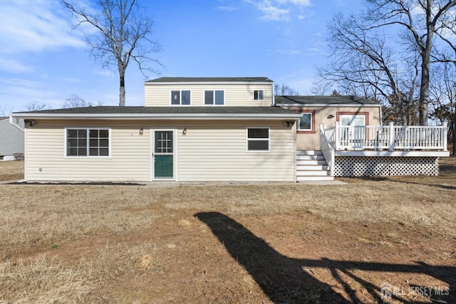 back of property featuring a wooden deck