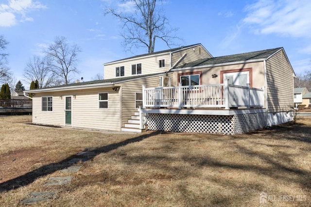 back of house with a yard and a wooden deck