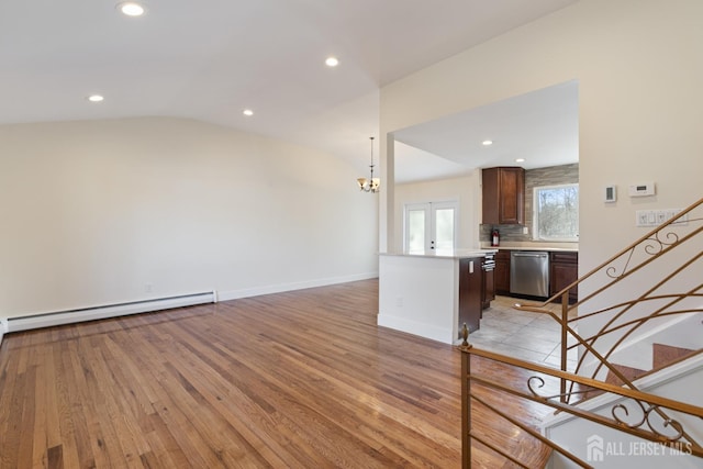 unfurnished living room with baseboards, stairs, lofted ceiling, recessed lighting, and light wood-style floors