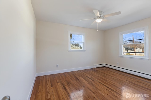 unfurnished room featuring wood finished floors, a healthy amount of sunlight, baseboards, and ceiling fan