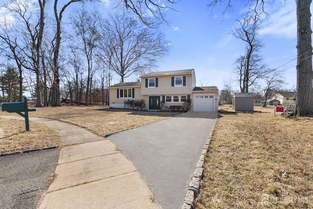 tri-level home with driveway, a front yard, and a garage