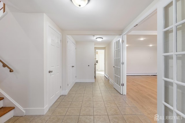 hallway with french doors, stairway, light tile patterned floors, a baseboard radiator, and baseboards