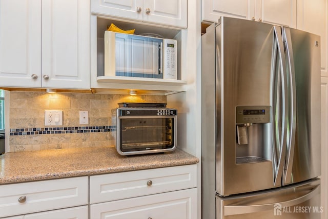 4 Wedgewood Ct, East Brunswick, NJ 08816 - kitchen featuring stainless steel refrigerator with ice dispenser, white cabinetry, backsplash, and light stone counters