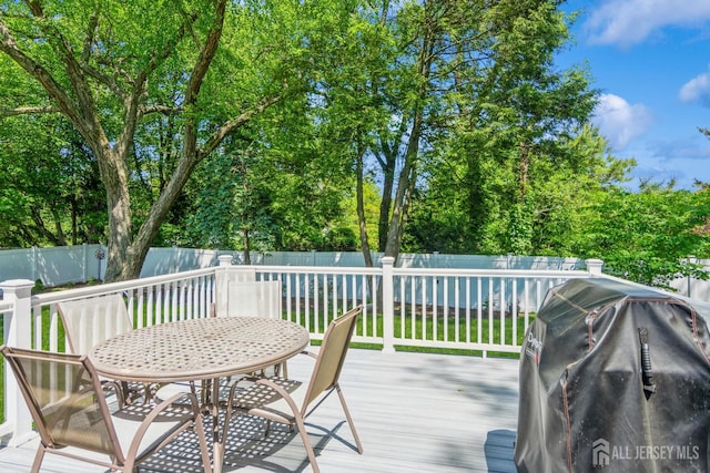 4 Wedgewood Ct, East Brunswick, NJ 08816 - wooden deck with a fenced backyard, outdoor dining space, area for grilling, and view of wooded area