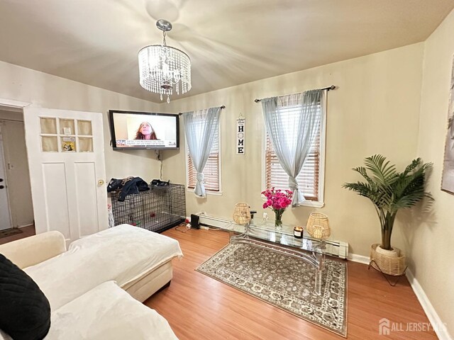 7 Hazelhurst St, New Brunswick, NJ 08901 - living room with a chandelier, a baseboard radiator, wood finished floors, and baseboards