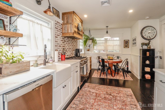 23 Elm Ave, Metuchen, NJ 08840 - kitchen featuring appliances with stainless steel finishes, light countertops, a wainscoted wall, white cabinets, and dark wood-style floors