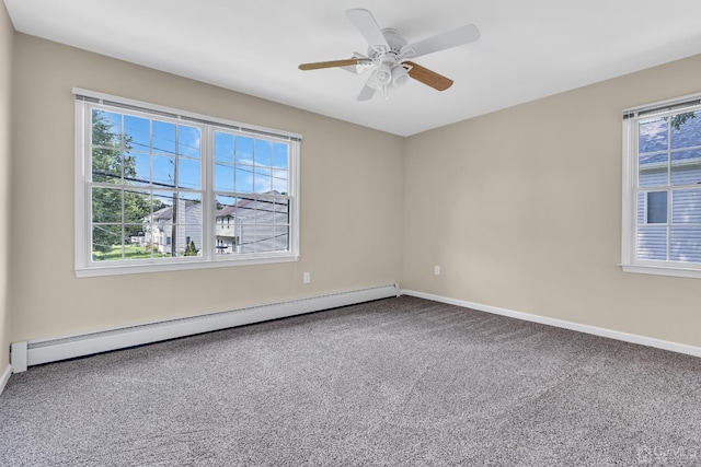 spare room with a baseboard heating unit, carpet floors, baseboards, and a ceiling fan