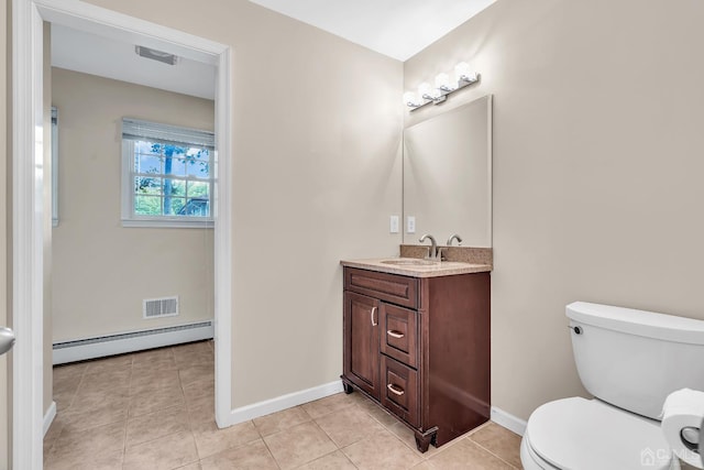 bathroom featuring visible vents, toilet, a baseboard heating unit, vanity, and tile patterned flooring