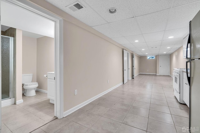 hallway with a paneled ceiling, baseboards, visible vents, and recessed lighting