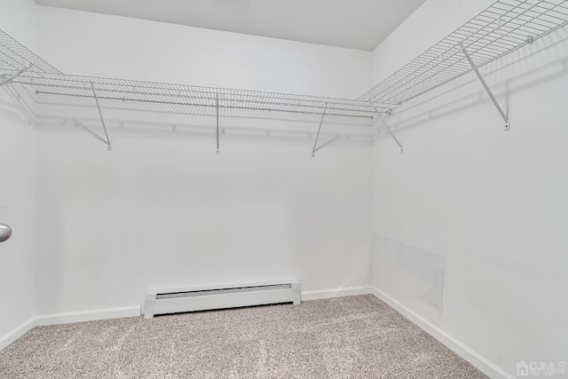 walk in closet with carpet floors and baseboard heating