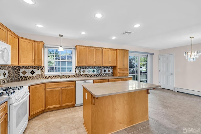 kitchen with a baseboard radiator, visible vents, hanging light fixtures, a sink, and white appliances